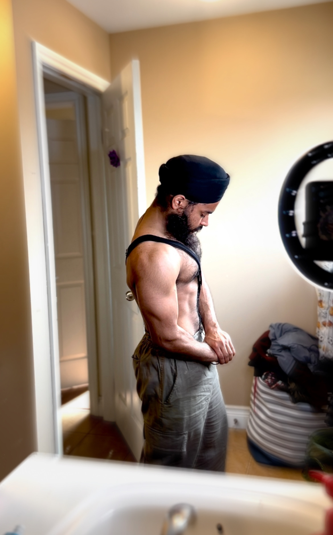 Karam Singh in profile, arms folded